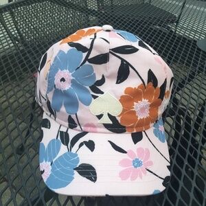Kate Spade Baseball Cap is pale pink with an all-over flower pattern in blue, ru